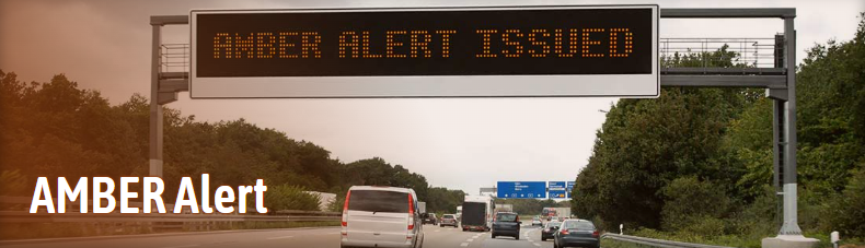 A highway with an AMBER alert sign